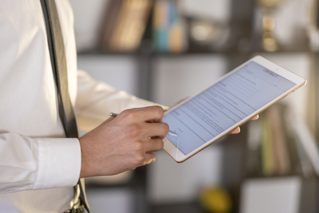 man reviewing contract on tablet
